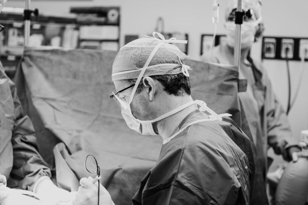 A tummy tuck surgeon performing surgery in the operating room 
